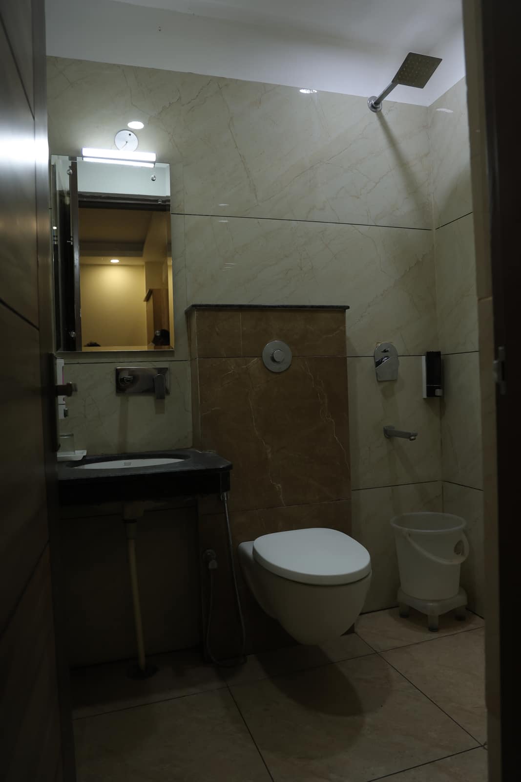 Modern marble bathroom with rain shower at Hotel Oriental